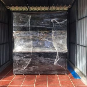 Commercial water filter machine wrapped in protective film dropped at the delivery point.
