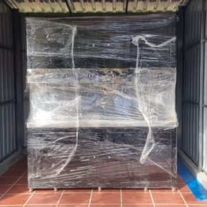 Front view of multi-tap commercial water purification machine wrapped for site installation.
